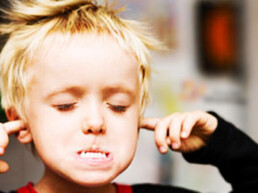 little boy kid blocking ears closing eyes