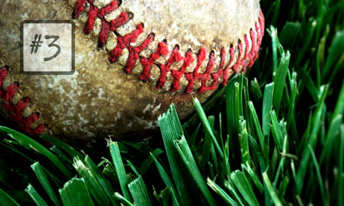 dirty baseball in grass close closeup