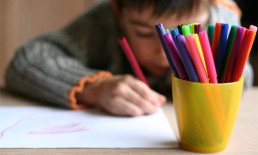 child drawing colored markers art