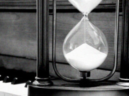 hourglass on piano keyboard black and white