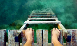 bare feet pier ladder water beach ocean