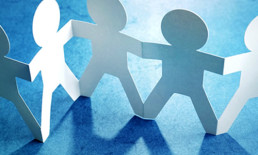 white connected paper dolls strand blue background