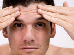 how to stop worrying man smoothing forehead wrinkles